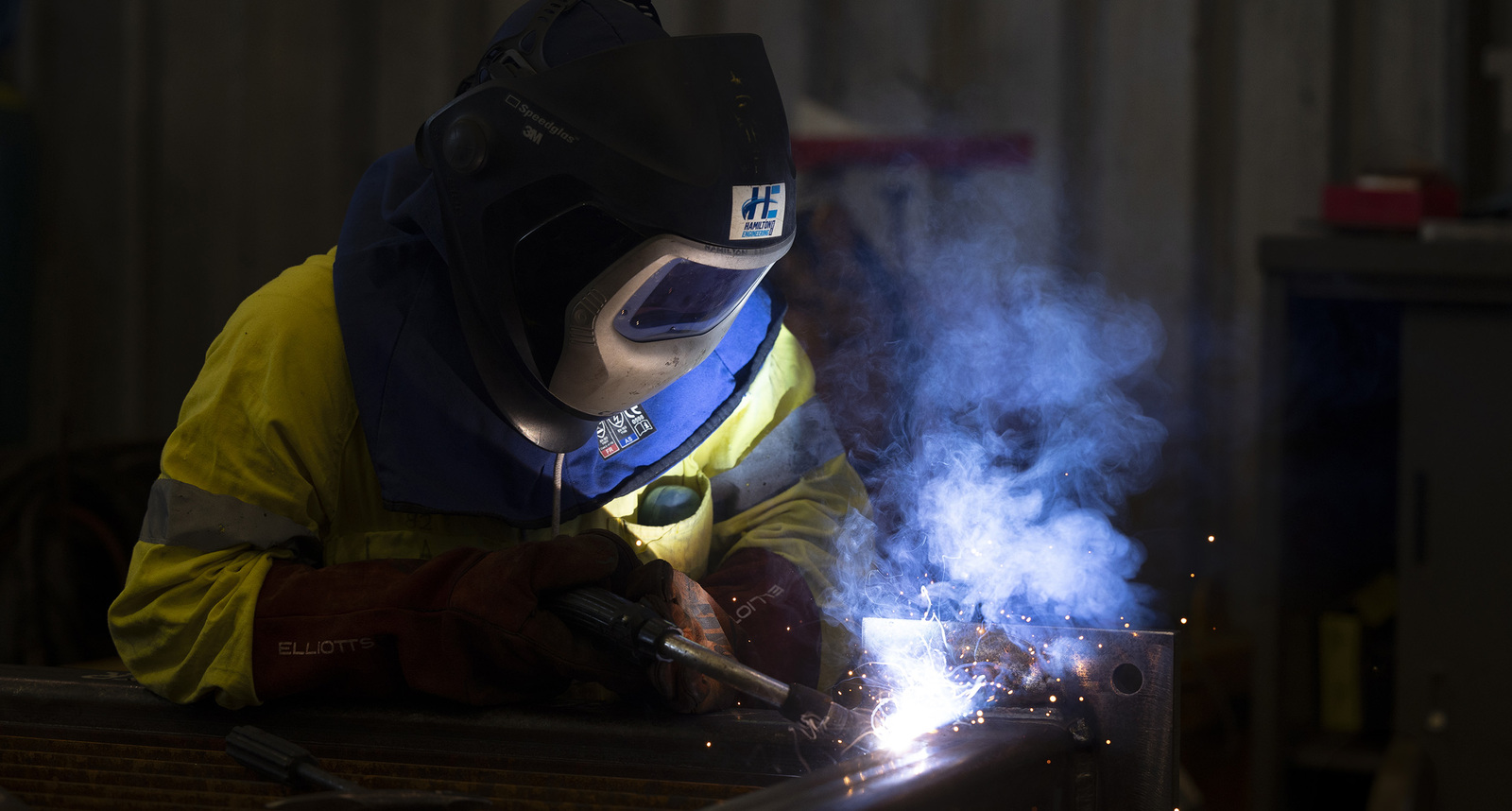Image of a welder working on steel